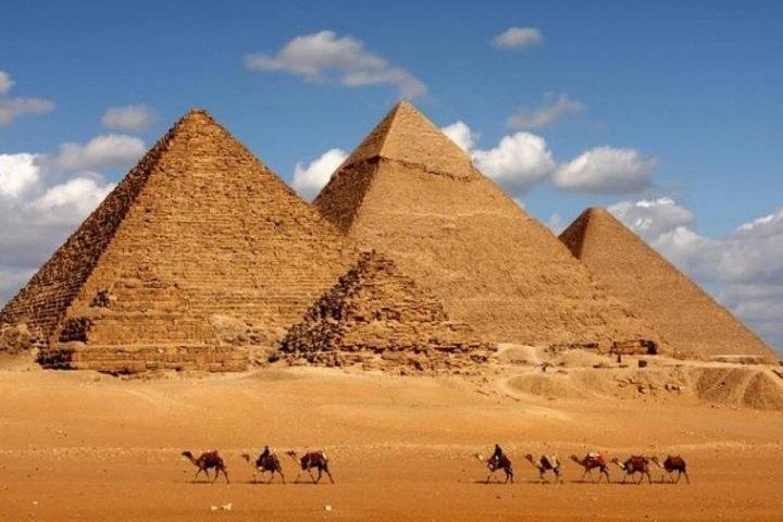 Camel Ride around the Pyramids During Sunrise Or Sunset
