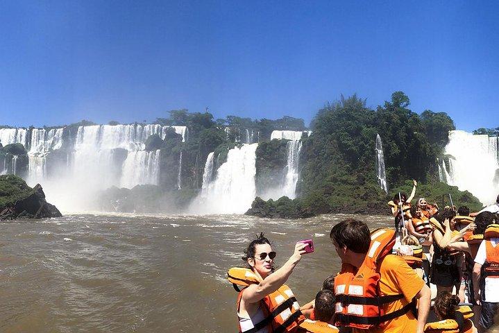 Motorboat under the waterfalls, 4x4 truck in the jungle with Argentine Falls