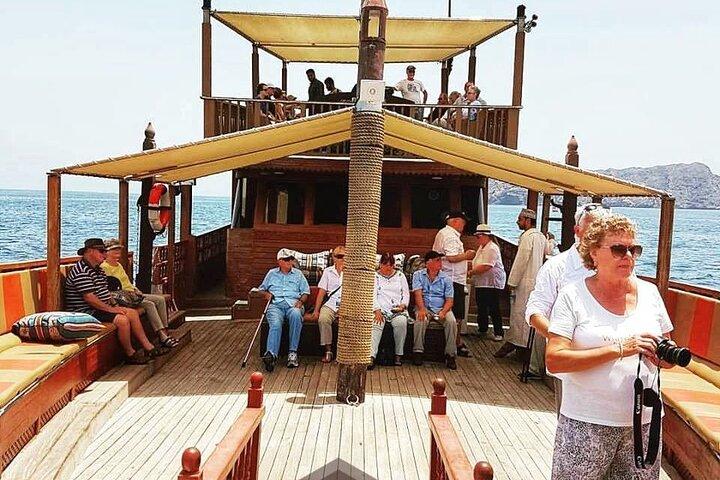 Omani Traditional Dhow Cruise: Sunset and Muscat Coastal View