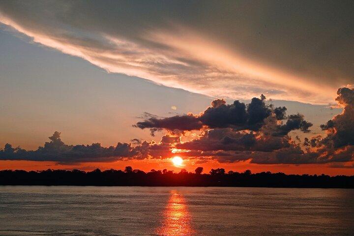 Sunset on the Amazon with fishing and pink dolphin search