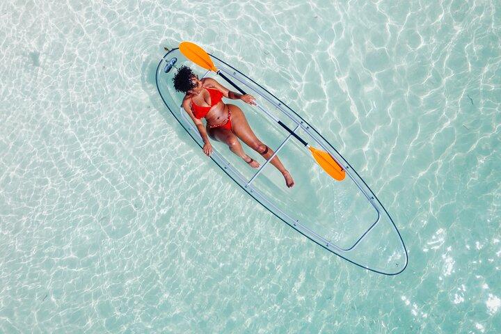 Explore Scenic Water in Transparent Kayak with Drone Footage