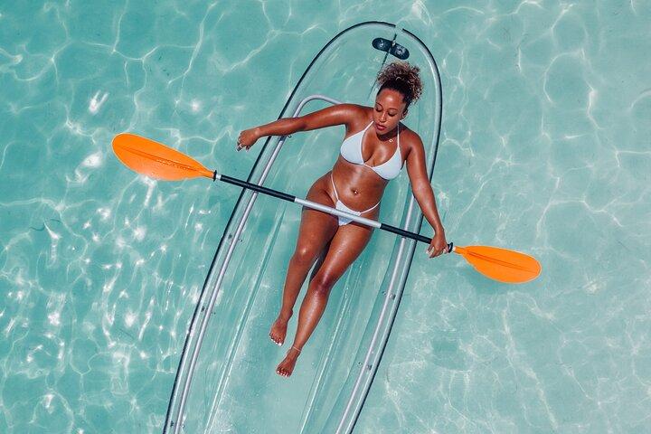 Explore Scenic Water in Transparent Kayak with Drone Footage