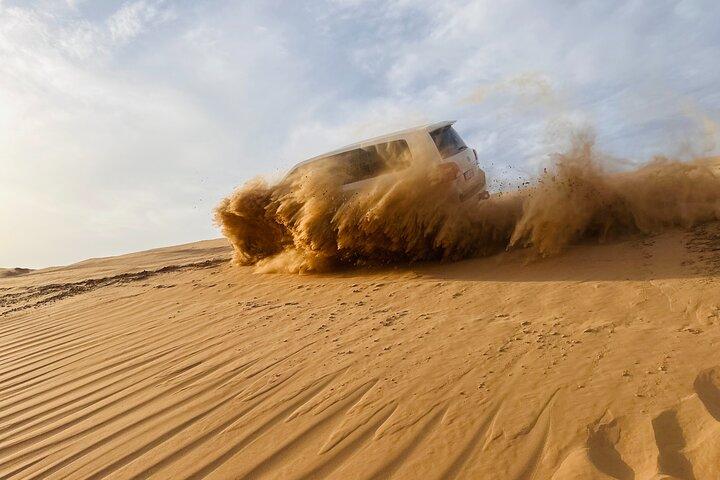 Abu Dhabi Morning Desert Safari with Camel Ride & Sandboarding