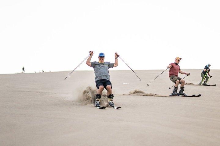 Sandboarding or Sand Ski in Huacachina Apresski bonfire Sunset