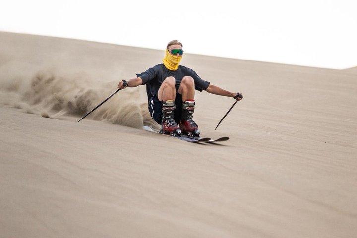 Sandboarding or Sand Ski in Huacachina Apresski bonfire Sunset