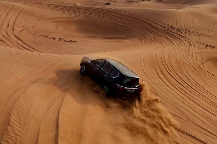Premium Desert Safari Camel Ride with Sandboarding and BBQ Dinner